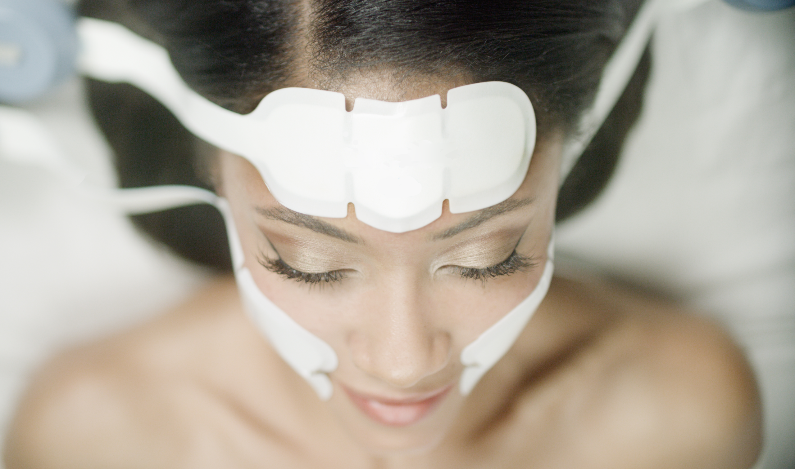 Woman relaxing during Emface facial rejuvenation session