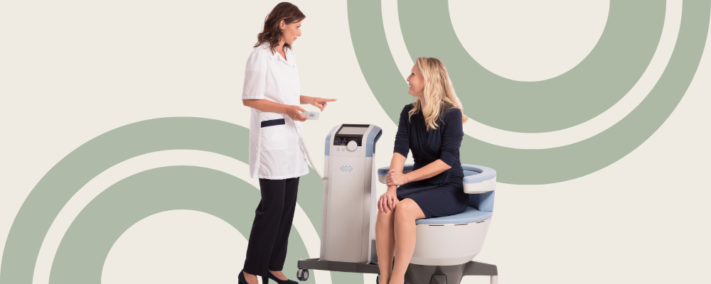 Provider preparing a patient for Emsella pelvic floor therapy treatment
